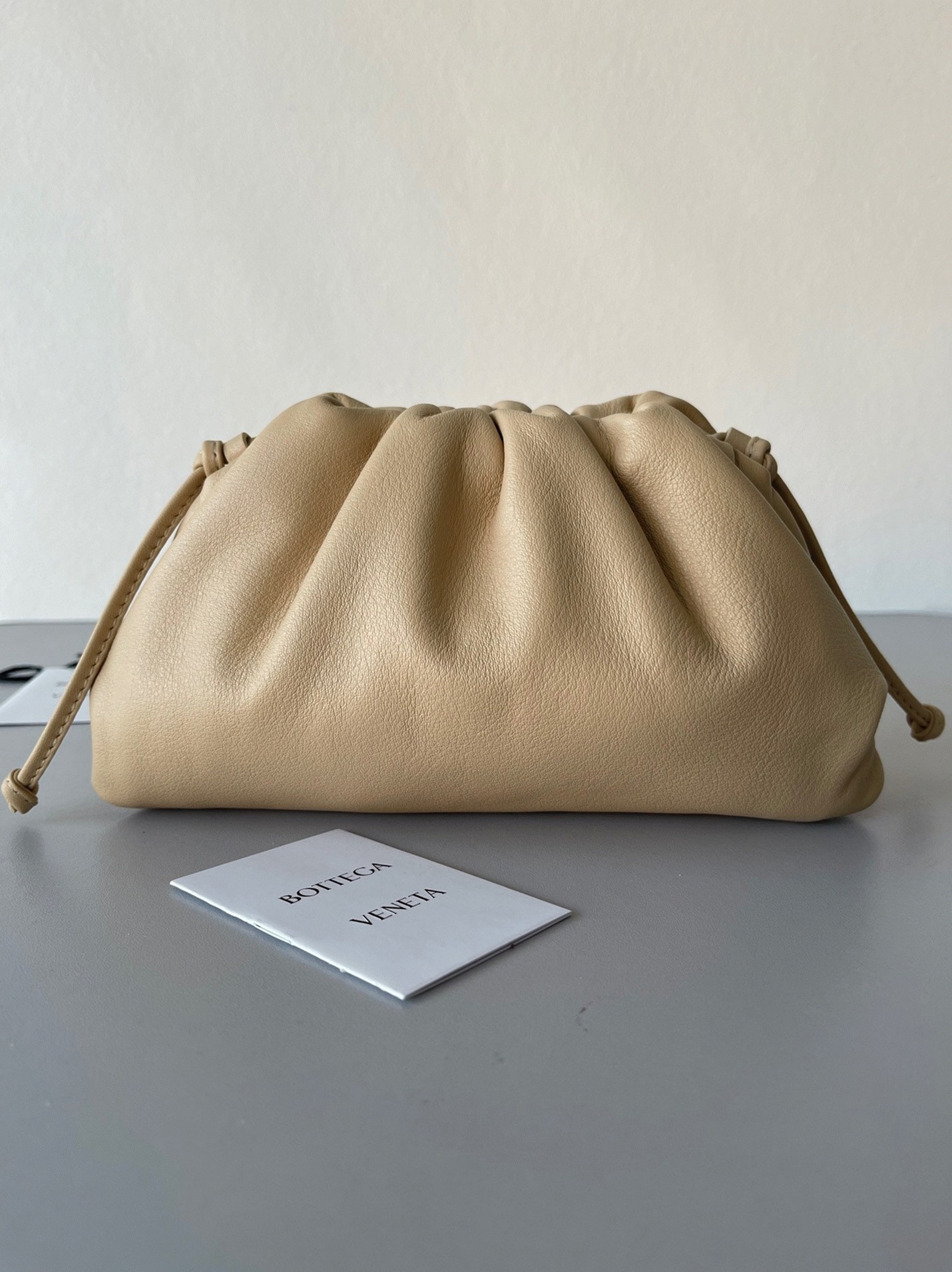 Fake B0tt*ga Ven*ta Mini Pouch with Strap Almond